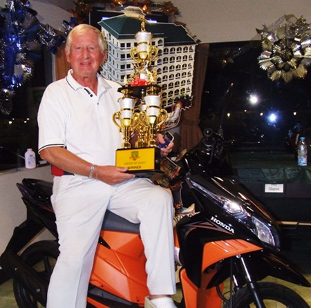 Jan Johansson poses with the series trophy and his gleaming new Honda Click motorcycle.
